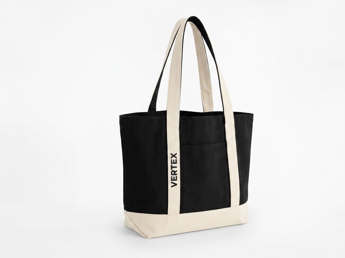 Two-tone black canvas tote bag with natural cream straps and contrast embroidered strap branding for Vertex Studio